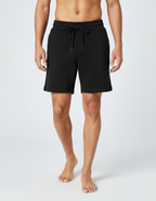 Euphor Bliss men's black terry shorts with an elastic drawstring waistband and relaxed fit on a model