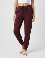 Euphor Bliss unisex joggers in deep burgundy cotton with a tapered fit, elastic drawstring waist, and ribbed cuffs.