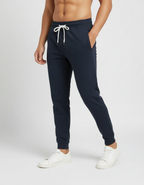 Euphor Bliss unisex navy blue cotton joggers with a tapered fit, ribbed cuffs, and drawstring waist on a model.